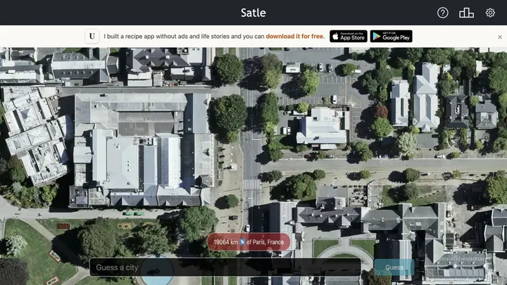 Satle satellite city view showing distance and direction after a Paris guess